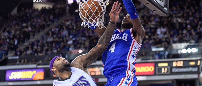Nerlens Noel of Philadelphia dunks over Kings center DeMarcus Cousins on Wednesday night.